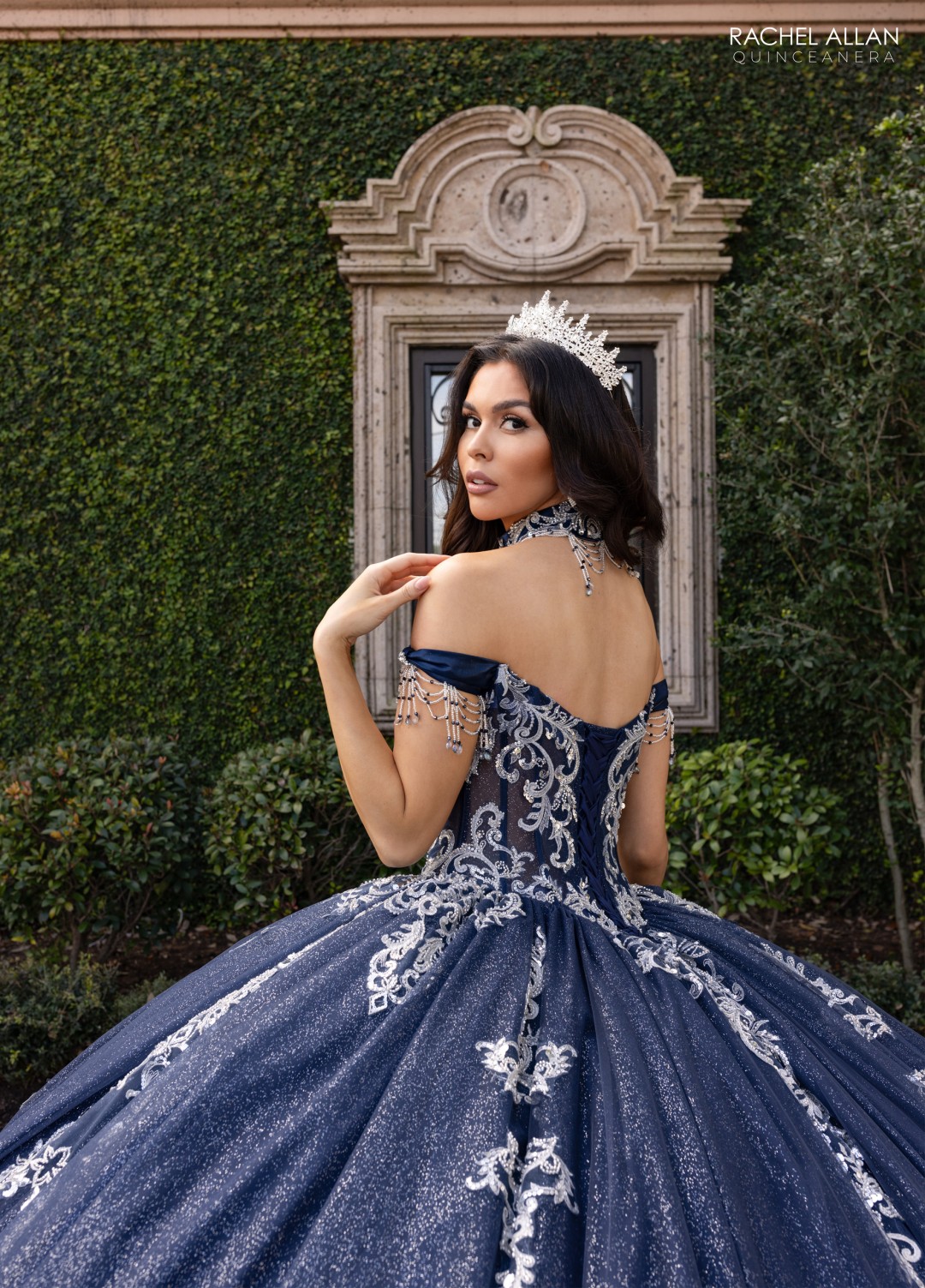 Blue La Reina Quinceañera gown featuring metallic embroidery and regal cape